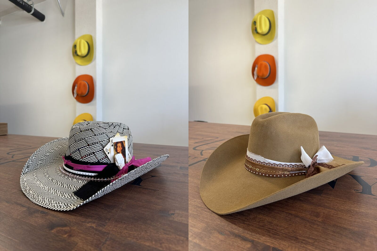 A woven straw cowboy hat with a pink band next to a tan felt cowboy hat on the styling table at Wild Pony Hat Bar in San Antonio