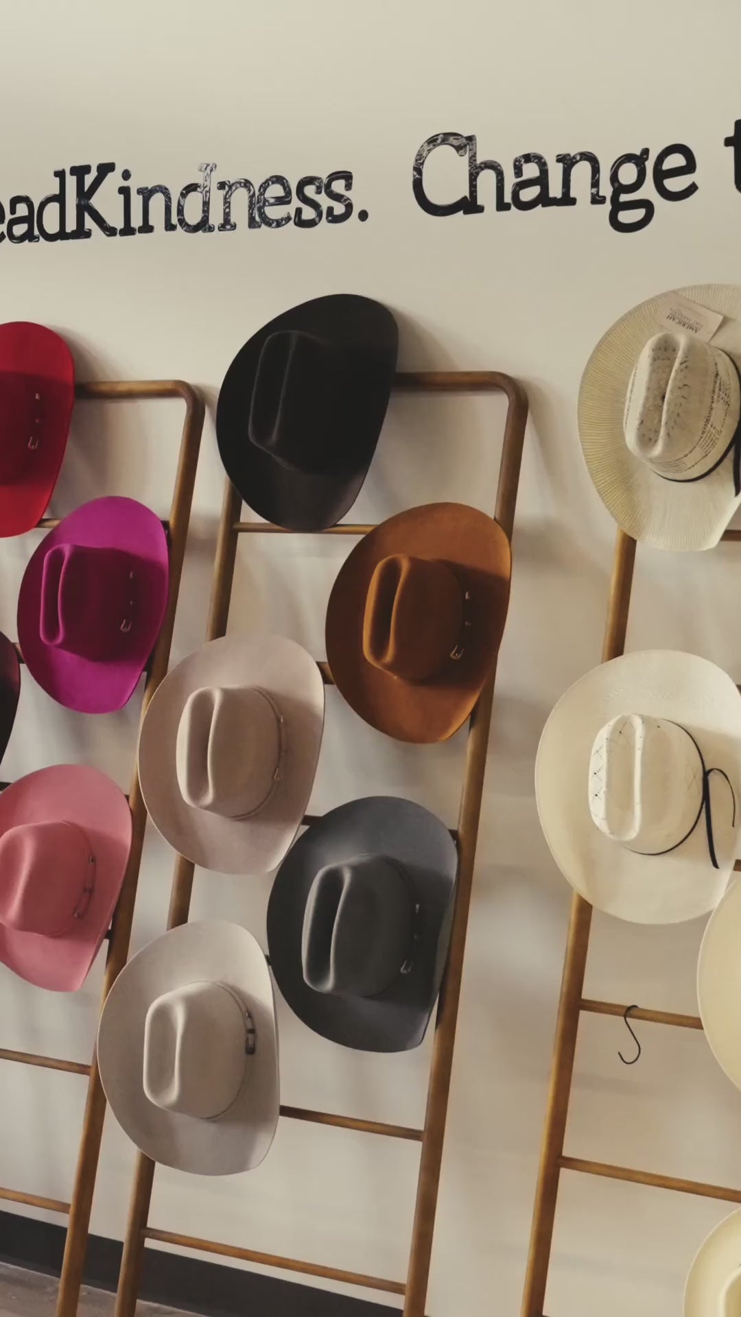 Load video: Guests building custom cowboy hats and gathering on the lawn at Wild Pony Hat Bar inside Basila Frocks in San Antonio