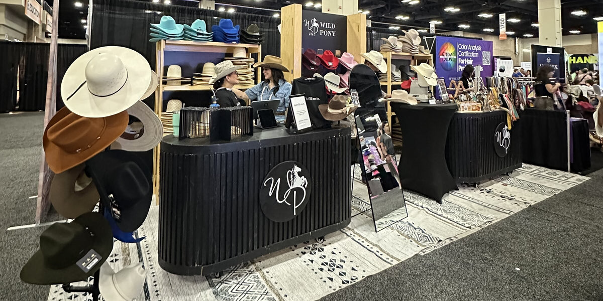 Wild Pony Hat Bar booth with a hat wall, custom hat bands and a styling counter at an expo