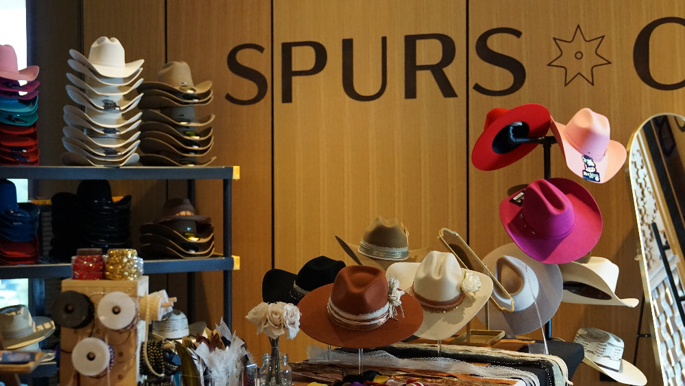 Large group corporate event with custom cowboy hats in San Antonio